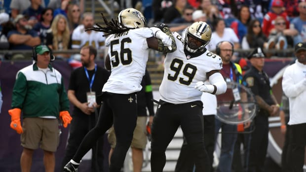 Saints' Demario Davis and Khalen Saunders react after a fourth down stop against the New England Patriots during the second half at Gillette Stadium